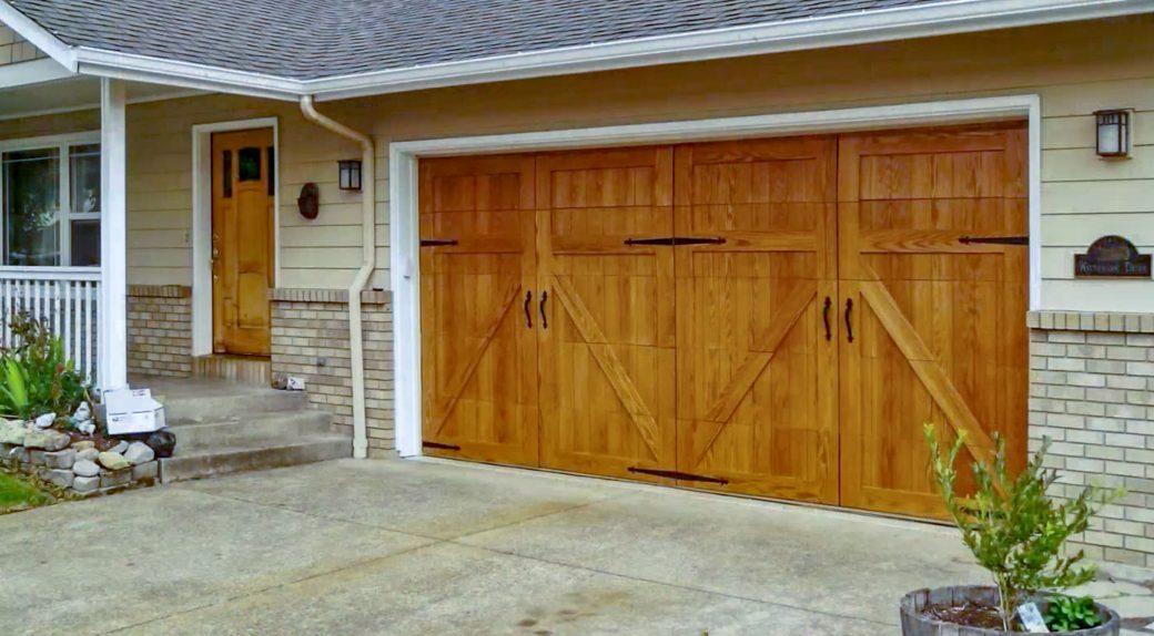 The Use Of Decorative Hardware Makes These Clopay Canyon Ridge Collection Faux Wood Carriage Style Doors Garage Doors Garage Door Styles Faux Wood Garage Door