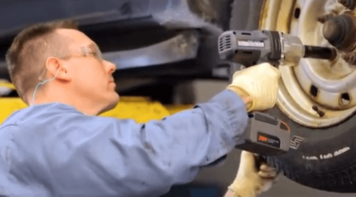 Auto mechanic using Ingersoll Rand W7150-K2 Impact Wrench to remove a wheel