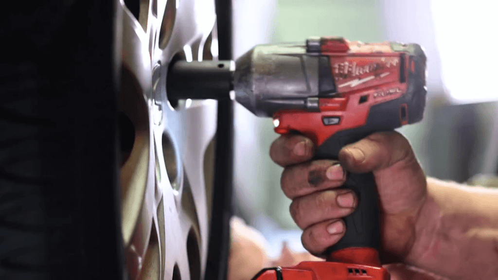 Man removing wheel with Milwaukee M18