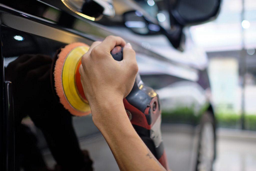 detailing professional buffing a black car