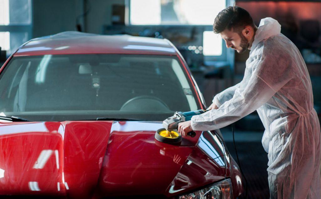 detailing tech polishing a car