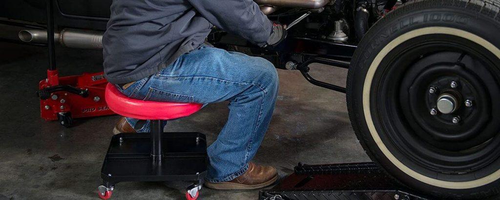 Auto mechanic using creeper seat