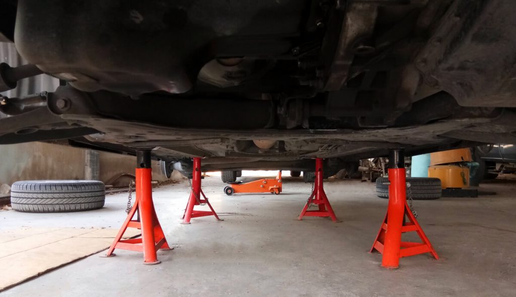 4 jack stands under a car