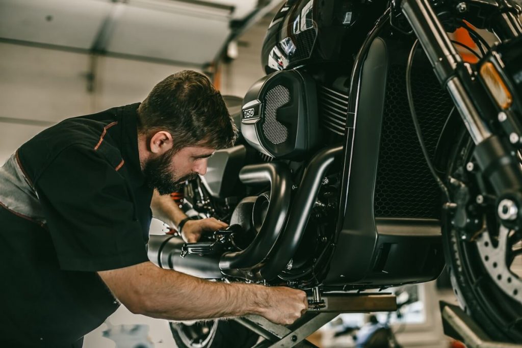 Mechanic working with motorcycle jack