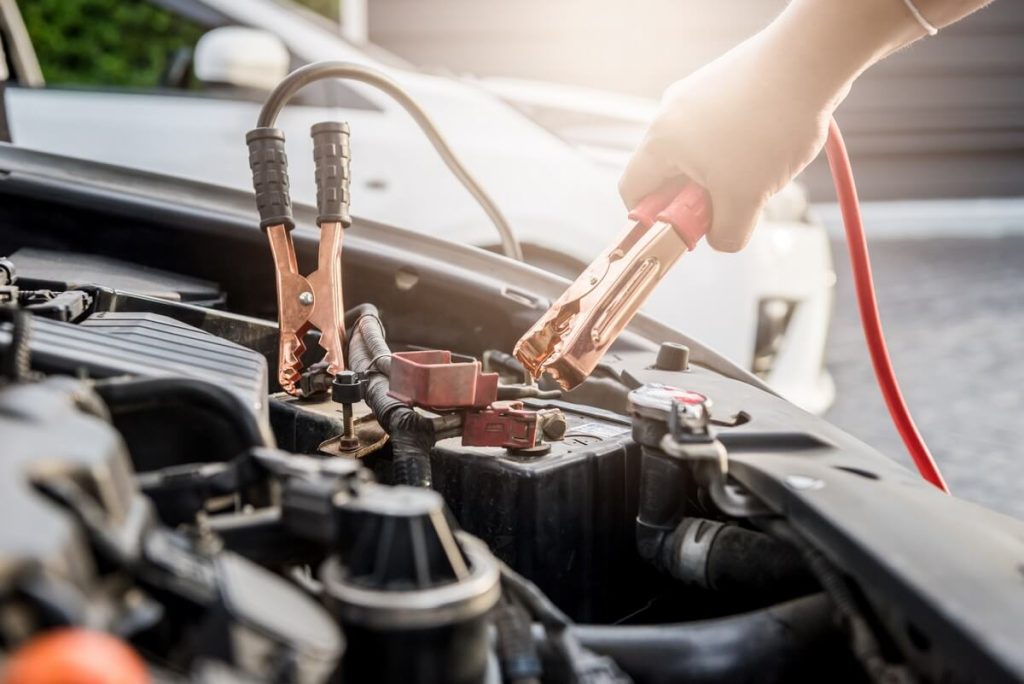 Mechanic charging car battery