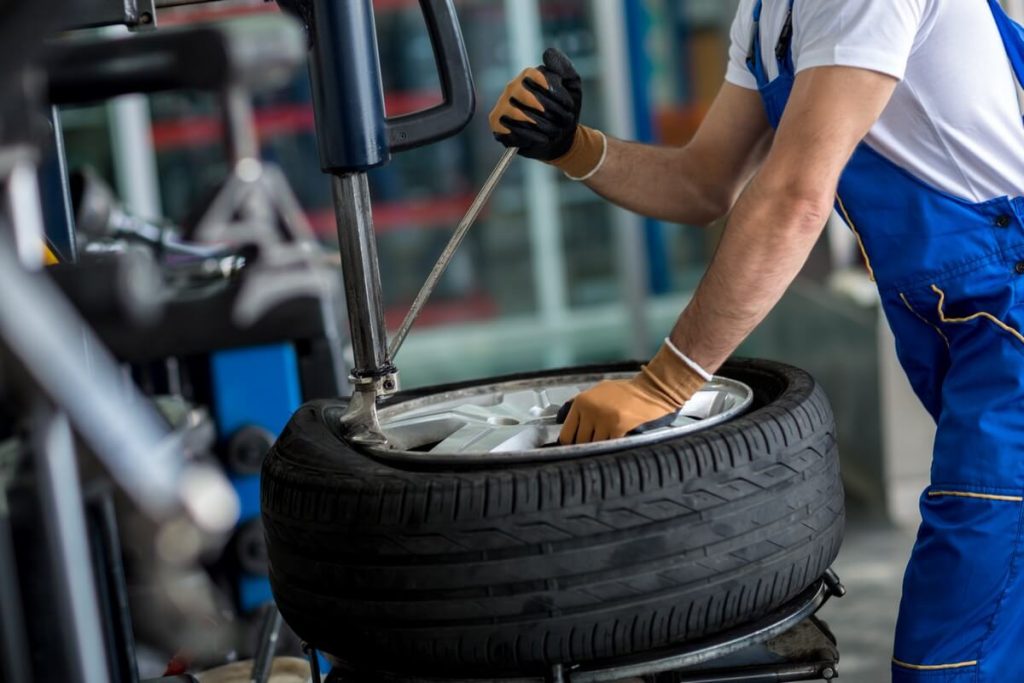 mechanic replacing a tire