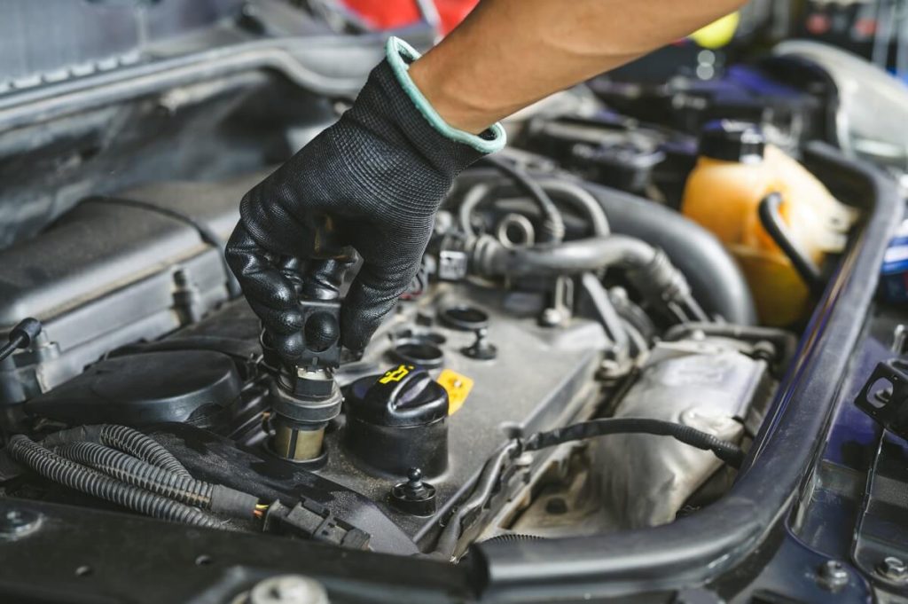 Mechanic changing coil-on-plug with gloves