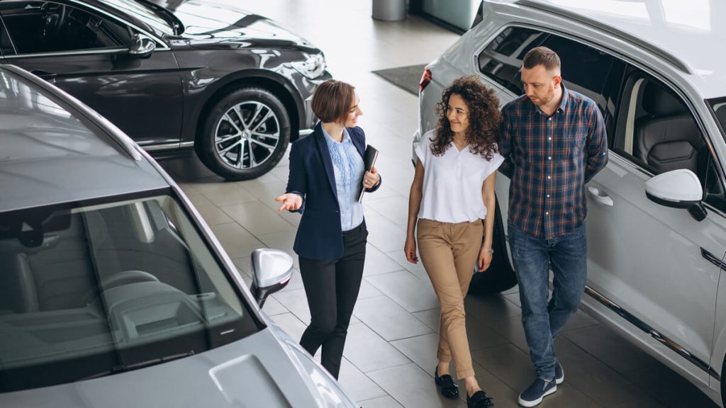 young couple buying a new car